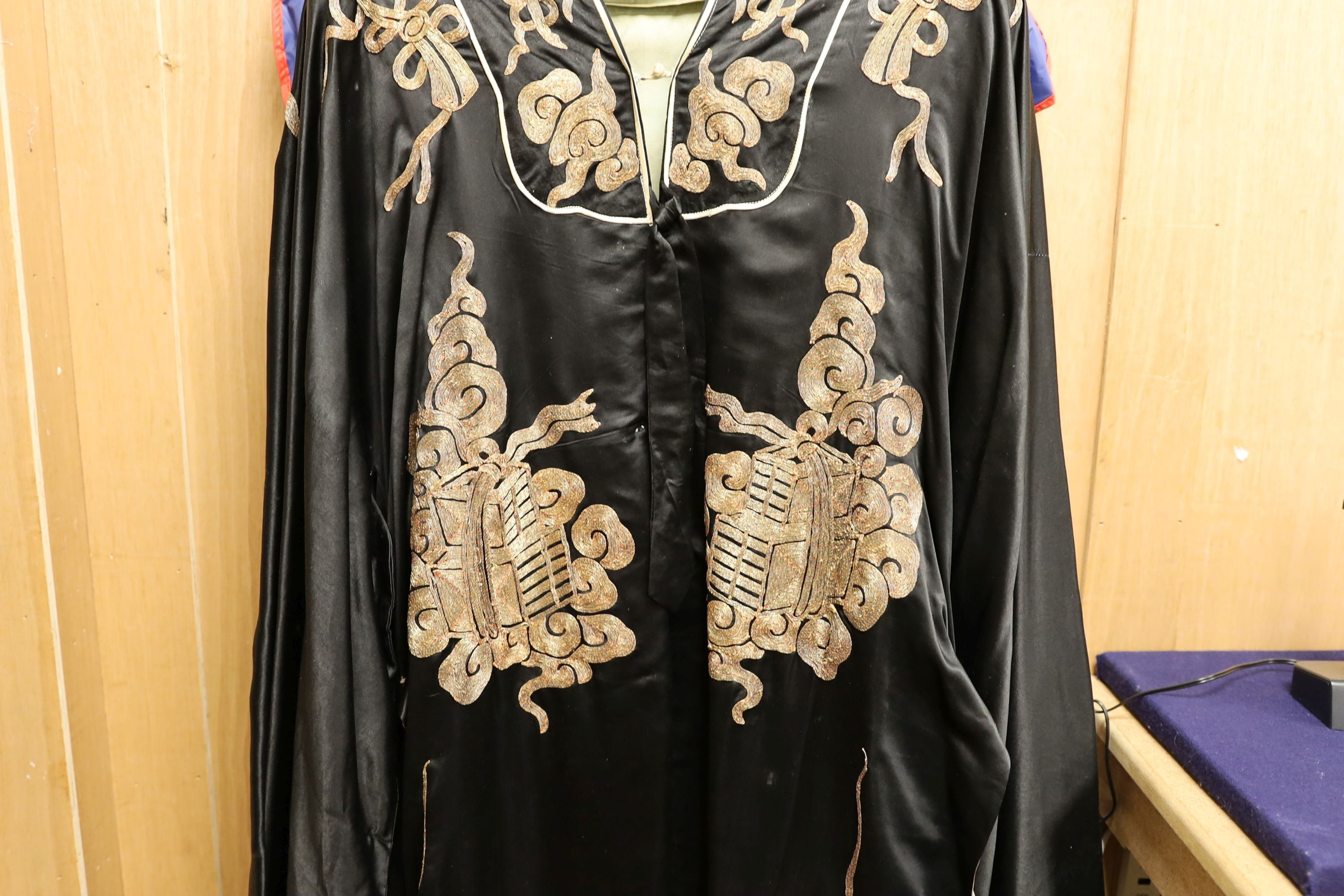 A Chinese black silk and silver thread robe, 44cm across shoulders